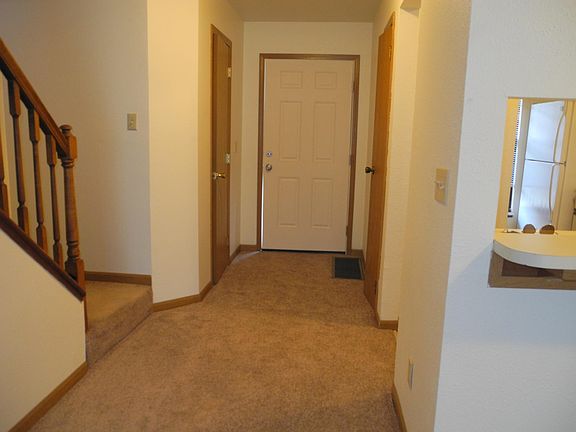 View of entry with "guest" half bath on left, closet on right