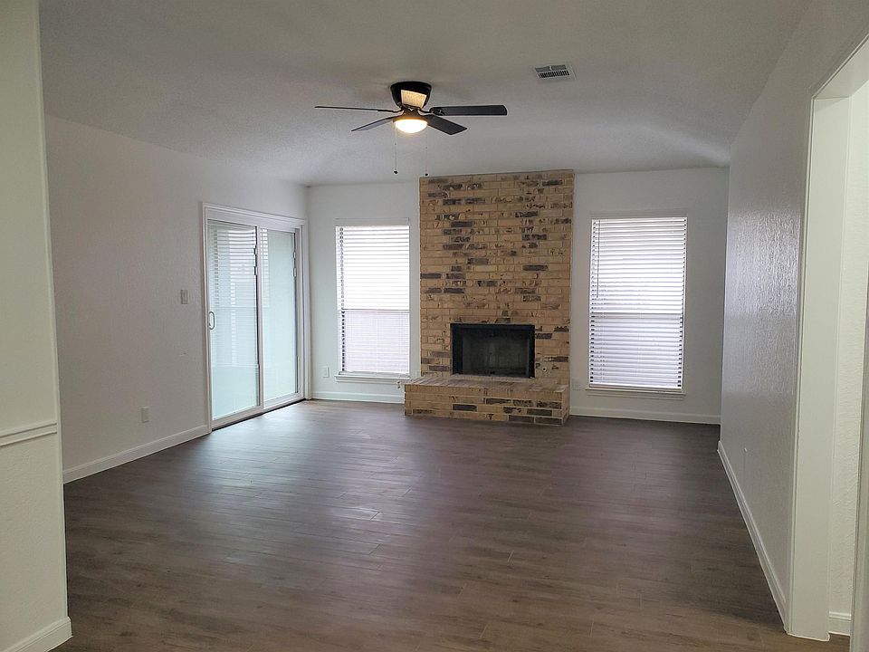 Living room with fireplace and access to backyard