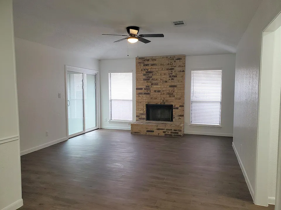 Living room with fireplace and access to backyard