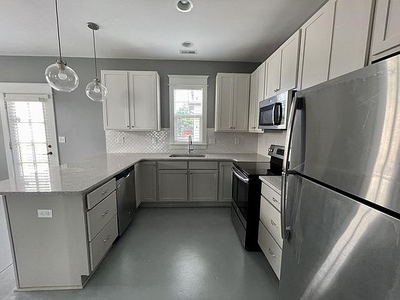 Quartz countertop, stainless steel appliances, good cabinet space.