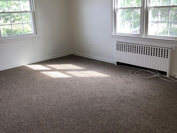 Bright, airy living room with views of Ash Creek. Access to