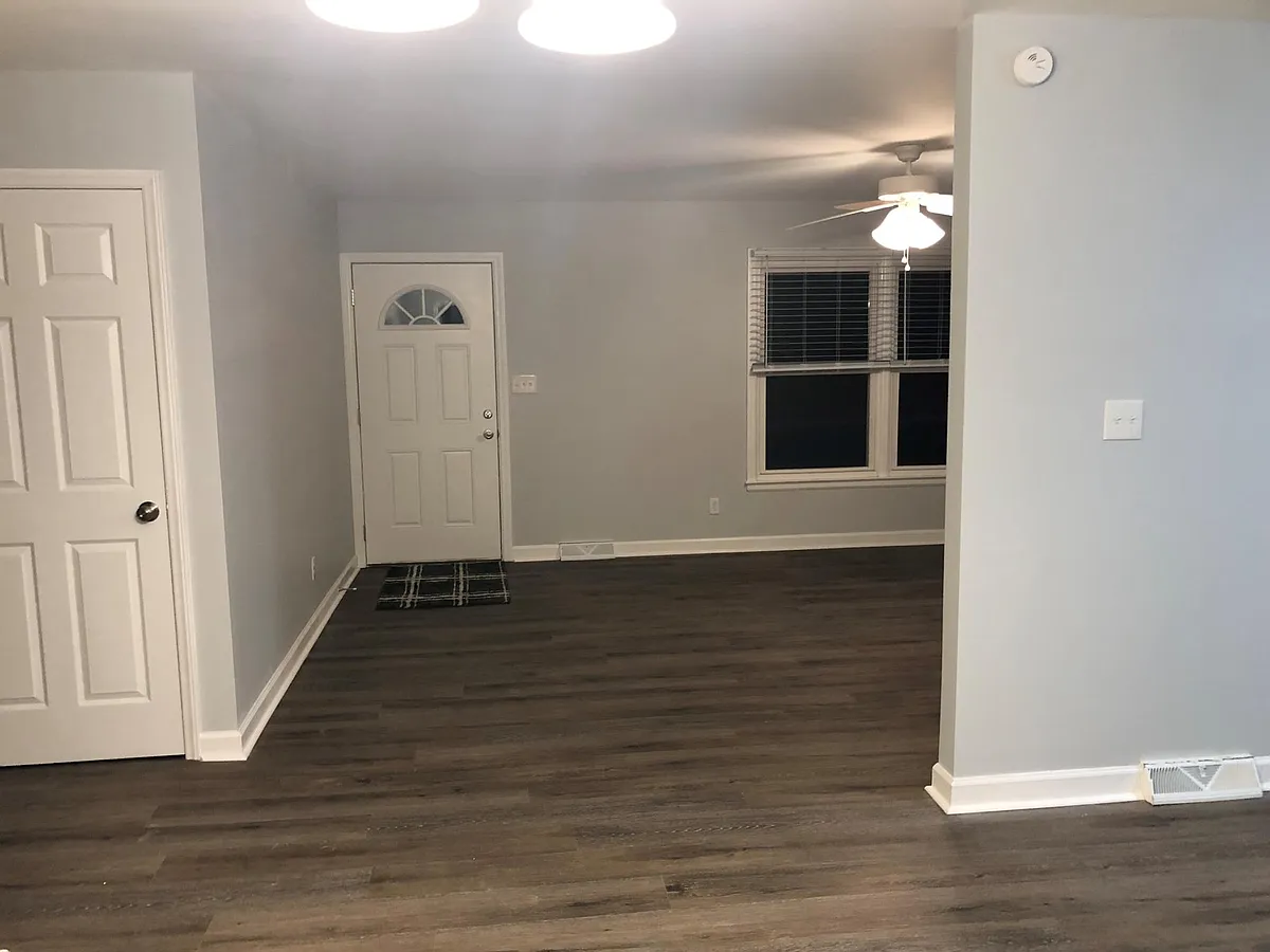 Photo 2 of 25 - 434 Matthews Mint Hill Rd - Matthews, NC Family room and front door. Laundry room door is on the left. - 434 Matthews Mint Hill Rd