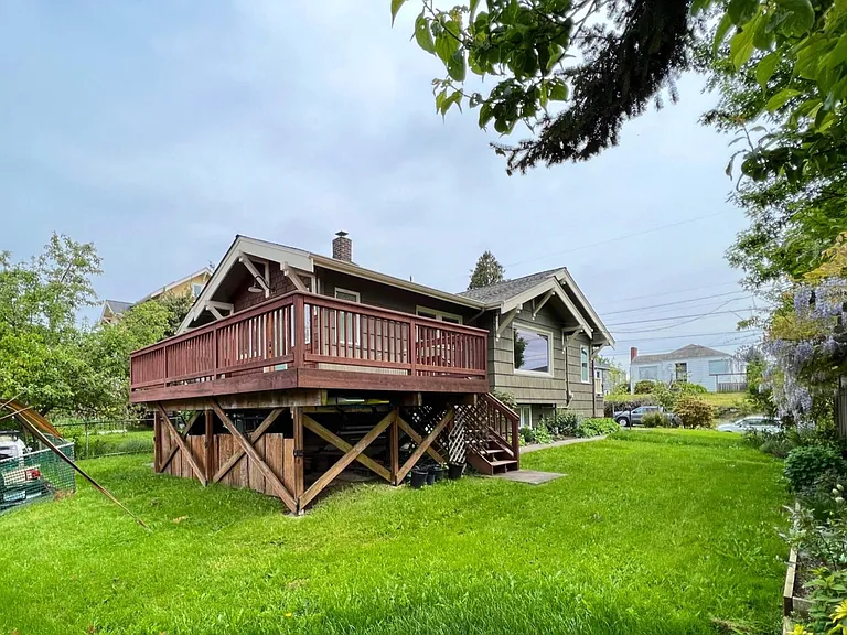 large deck with partial views of the Olympic Peninsula and private back-alley parking