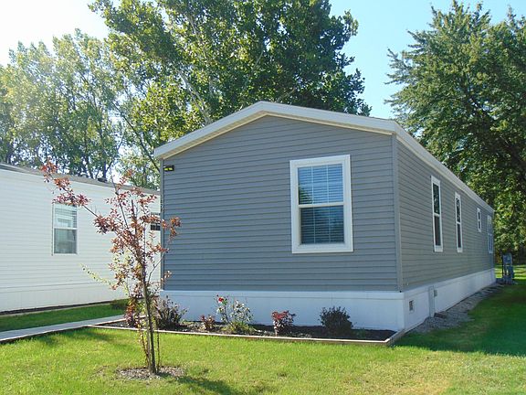 Front View of the home showing a Beautifully tree lined back area.