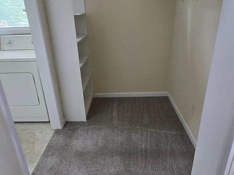 Large closet off upstairs master with adjoining laundry room and bathroom