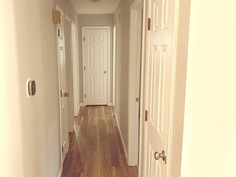 A central hallway connects the living room to three bedrooms and a full bathroom. On the left are Bedroom #1 and Bedroom #2; on the right are Bedroom #3 and the bathroom