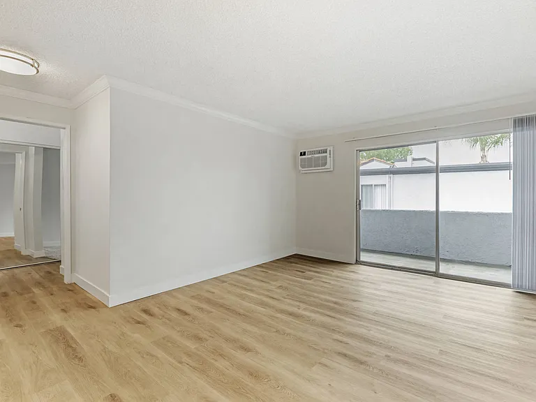 Cornerstone Apartments offer spacious living rooms with fresh flooring, seamlessly connected to nature through sliding glass doors leading to your private balcony.