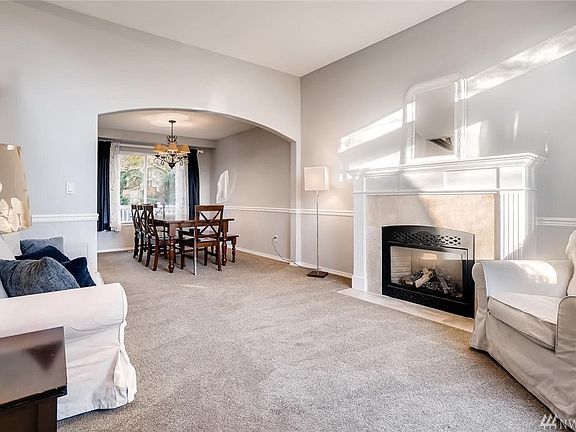 Living room off entry with gas fireplace for those chilly days, opening to formal dining room.
