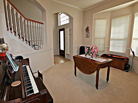 ENTERTAINING WILL BE A DELIGHT IN THE FORMAL DINING ROOM WITH CROWN MOLDING, CHAIR RAILING, AND A BA