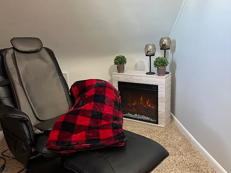 Relax and read a book in the bedroom by the fireplace.