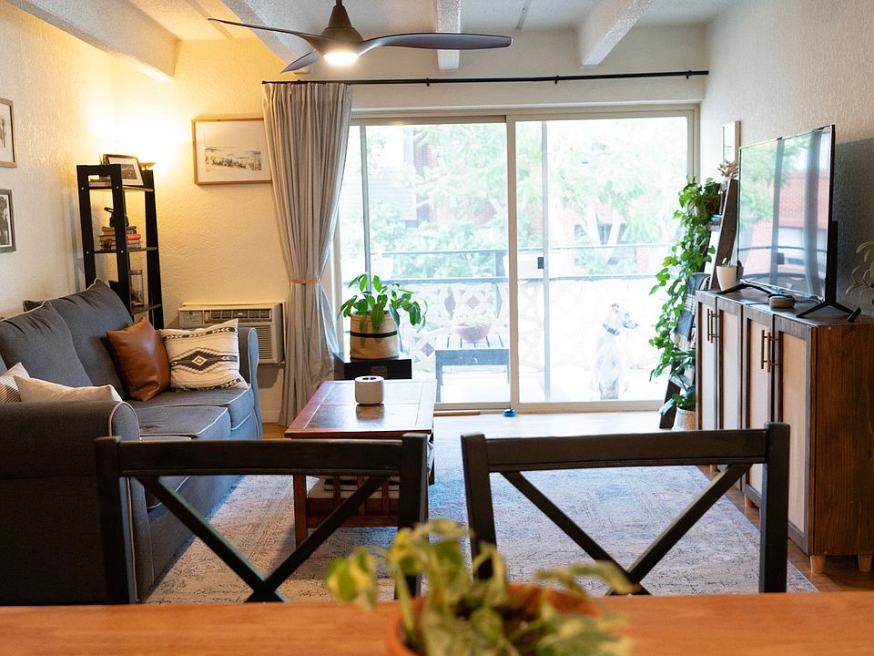 Living room receives plenty of natural light. Plants love the sliding glass door.