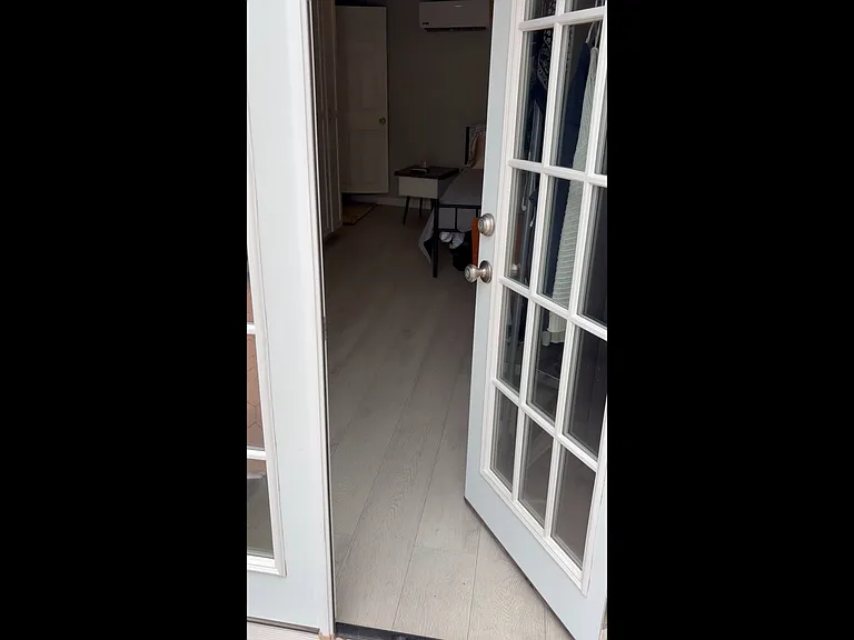 French insulated doors covered by gray blackout drapes