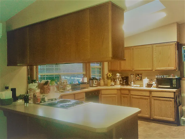 Kitchen with tons of counter space including stove, oven, dishwasher, microwave, big refrigerator with filtered water and ice dispensers, kitchen aid mixer, Cuisinart food processor, Instant Pot, and toaster oven