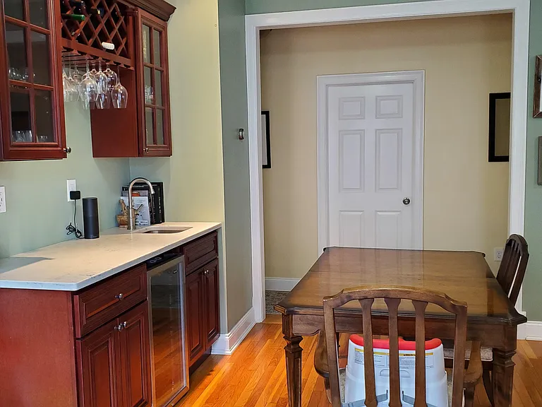 Dining room area with wet bar and mini fridge. Door seen is bedroom 3