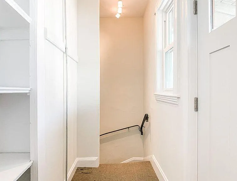 First floor rear hallway with pantry & access to rear exit to parking