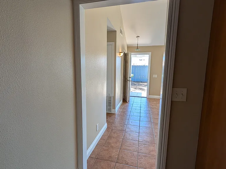 Hallway from first living room into the kitchen