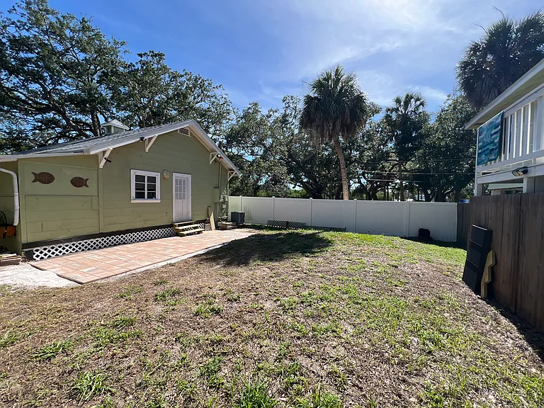 fenced in backyard with patio pavers: Carriage house on right has a one car bay for storage, included in rent