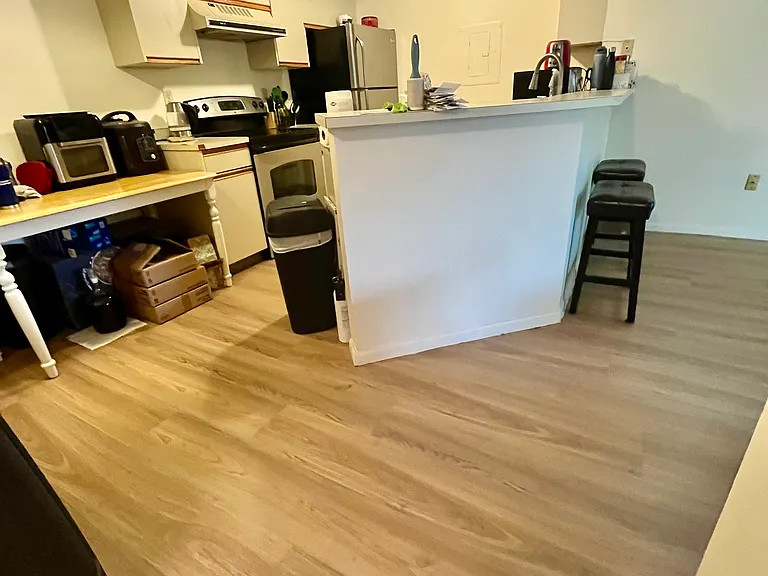 Kitchen with 3 newer cooktop, 1 year old dishwasher, full size refrigerator.