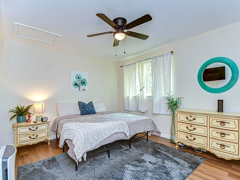 Bedroom features a 32" smart tv, comfortable king size bed, dressers along with a large walk in closet and ensuite bathroom
