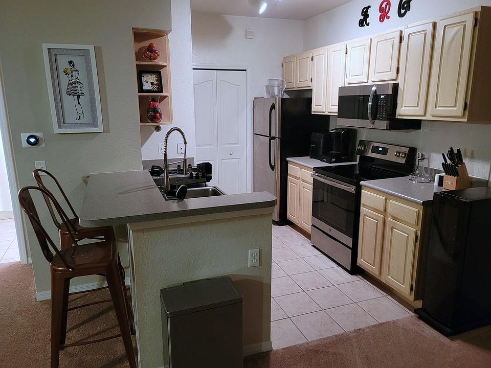 Nice kitchen with upgraded appliances with adjacent laundry room with washer, dryer & shelves.