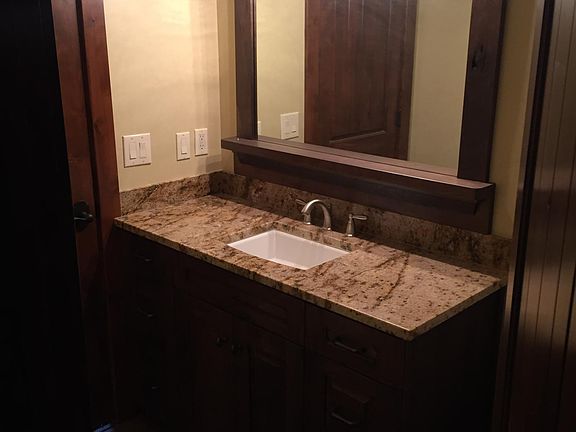 Adult height Walnut Cabinet. Tile Shower and Tub, ADA toilet ( your knees aren't in your chin)