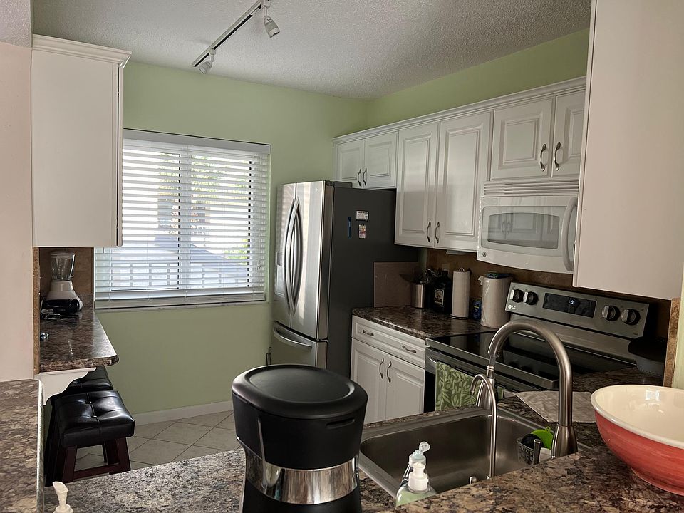 Kitchen with new oven and refrigerator, appliances, utensils and filtered drinking water system