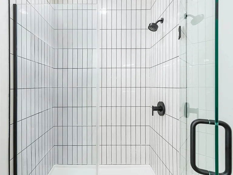 Crisp lines and sleek finishes define the contemporary showers at Modera Higley Commons.