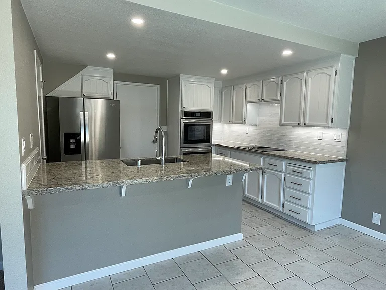 Completely updated kitchen, new countertops, undercabinet lighting, new stainless steel appliances and new sink, fresh paint.