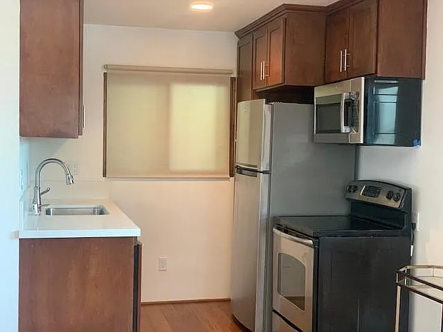 Stocked kitchen with dishwasher.