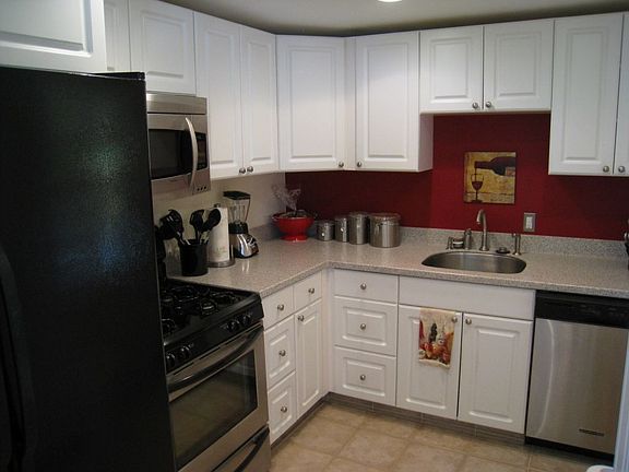 Modern, high end kitchen with Corian countertop, ceramic tile, KitchenAid DW..