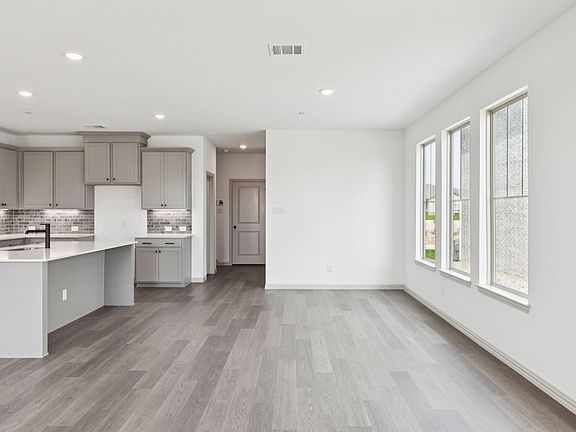 Living room in the Hansen Floorplan at Village at Midtowne in Midlothian, TX.