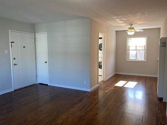 Living room front entry and coat closet looking to dining room and kitchen