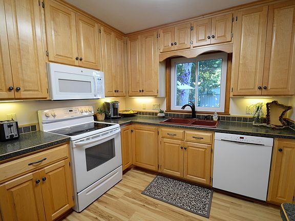 Custom maple cabinetry extends to the ceiling for elegant look and added storage space