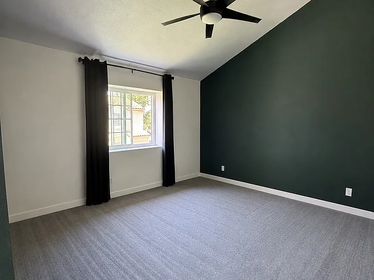 Primary bedroom, ceiling fan, large double closet, blackout draperies, and attached full
En suite/primary bath.