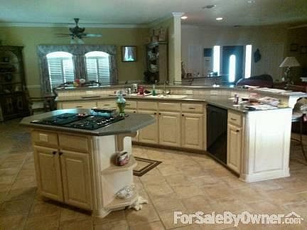 Open concept kitchen
						:
						Ample cabinets located on wall.