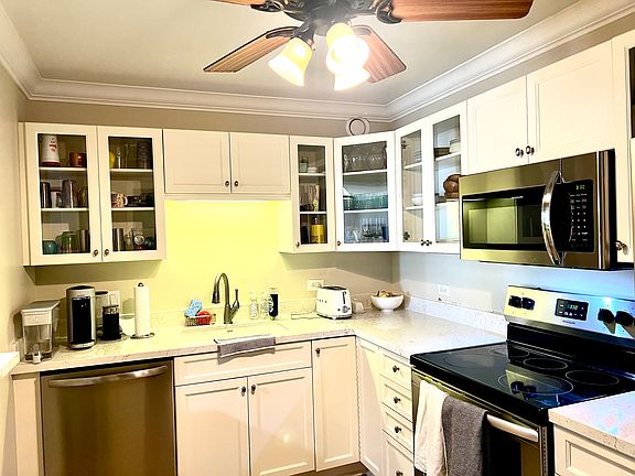 New stainless steel appliances and white kitchen