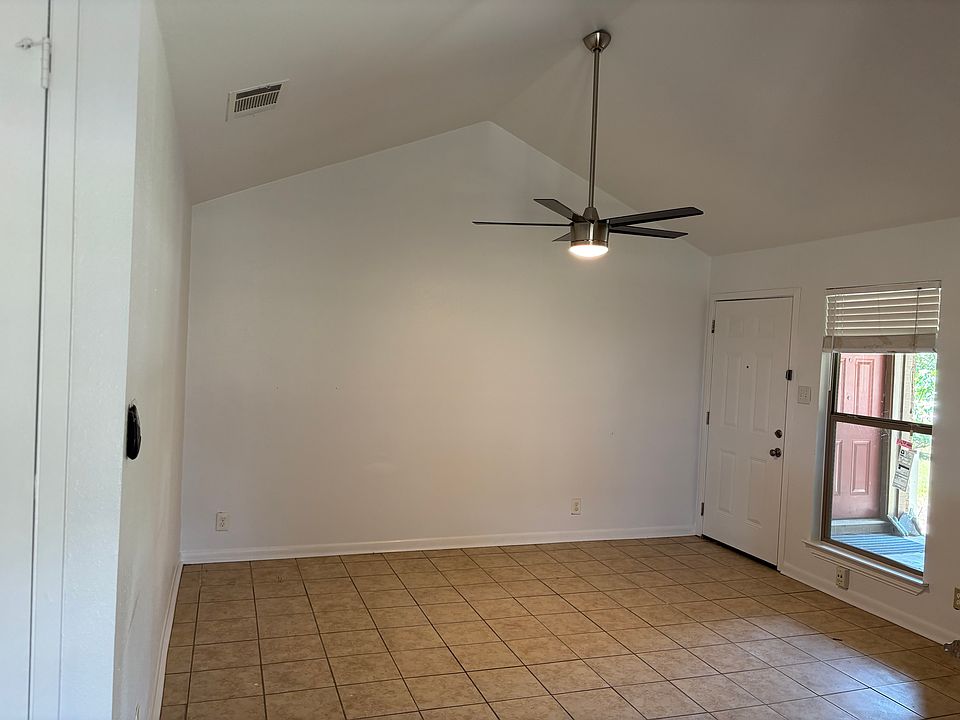 Fresh paint throughout home. Open living room with vaulted ceiling and new, modern fan.