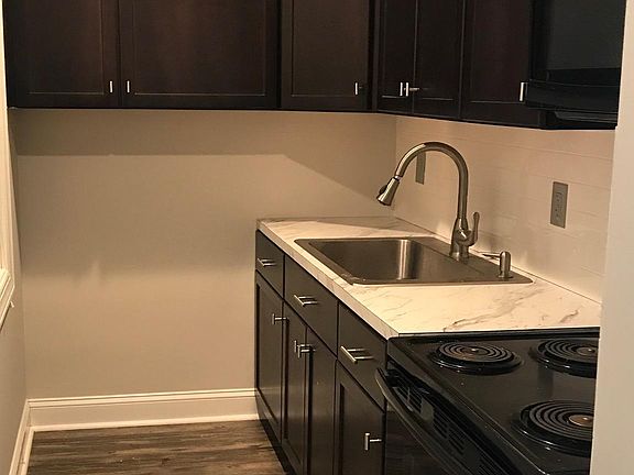 Remodeled kitchen with black cabinets - lots of storage! New stove and over-the-stove microwave.