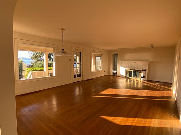 Spacious living room/dining room with fireplace and hardwood floors