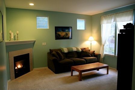 A gas fireplace frames the living room providing warmth and ambiance.