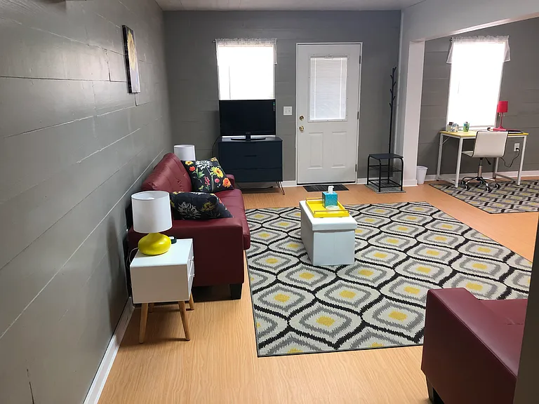Spacious living area with storage in tv stand and ottoman