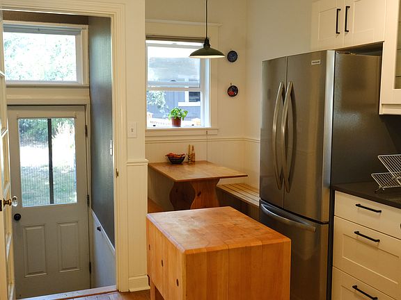 Kitchen, dining nook, back stairs to basement and backyard