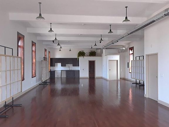 Looking north. Morning sun from the right. Sunsets on the left. Galley kitchen, laundry and bath at the far end keep the floor uninterrupted.