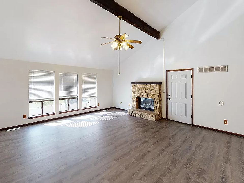 Huge living room with new luxury flooring, vaulted ceiling and LOTS of natural light.