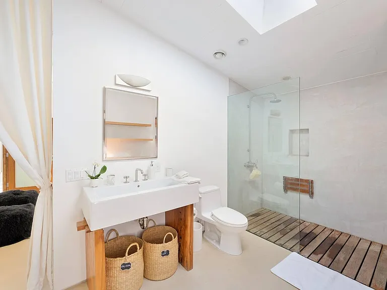 Expansive bathroom featuring an invigorating shower and abundant natural light streaming in through the skylight.