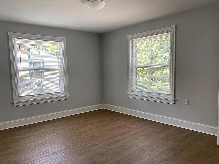 Bright and spacious bedroom with large windows, abundant natural light, and updated flooring. Freshly painted with neutral finishes, creating a clean and inviting living space.