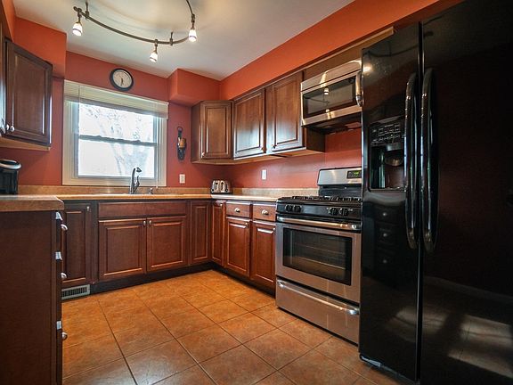UPDATE KITCHEN W/UPGRADED CABINETS, FIXTURES, COUNTER TOPS, PULL OUT FAUCET, LIGHTING, CERAMIC AND MORE!