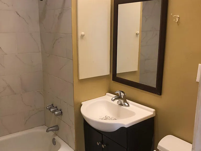 Beautiful white bathroom fixtures and flooring. Built in medicine cabinet, mirror. New lights and ceiling fans throughout home.