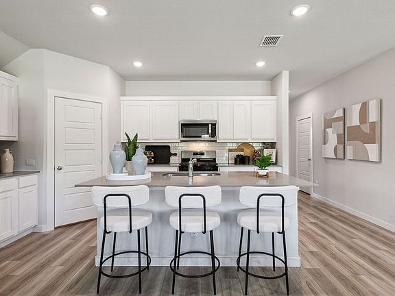 Kitchen in the Emmy II home plan by Trophy Signature Homes - REPRESENTATIVE PHOTO