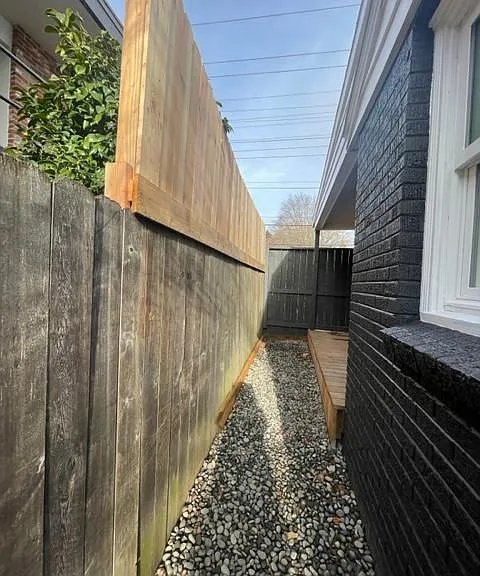 Walkway from backyard to side yard, high fence for extra privacy